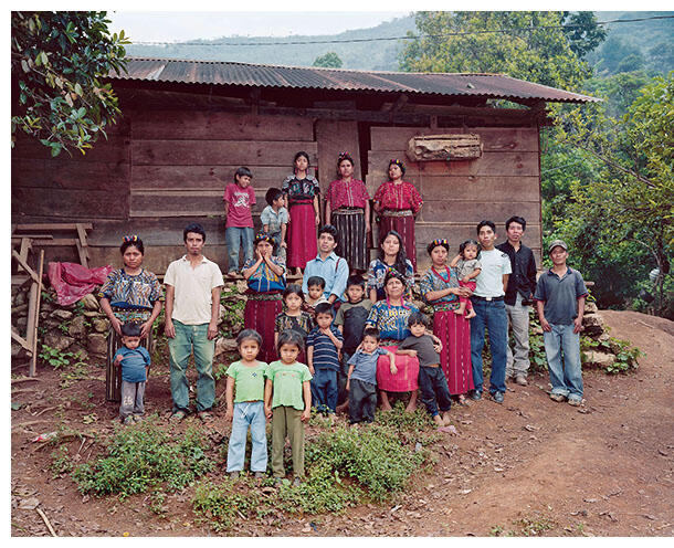 Maya families gathered outside a wooden home in the Guatemalan highlands